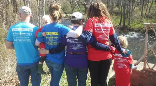 Family by river after River Cleanup.